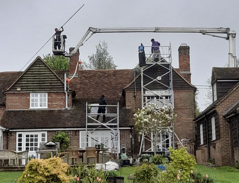 The Moss Cleaners using cherry picker and scaffolding to clean roof safely and professionally in London, 46A Bridge St, Pinner HA5 3JF, UK